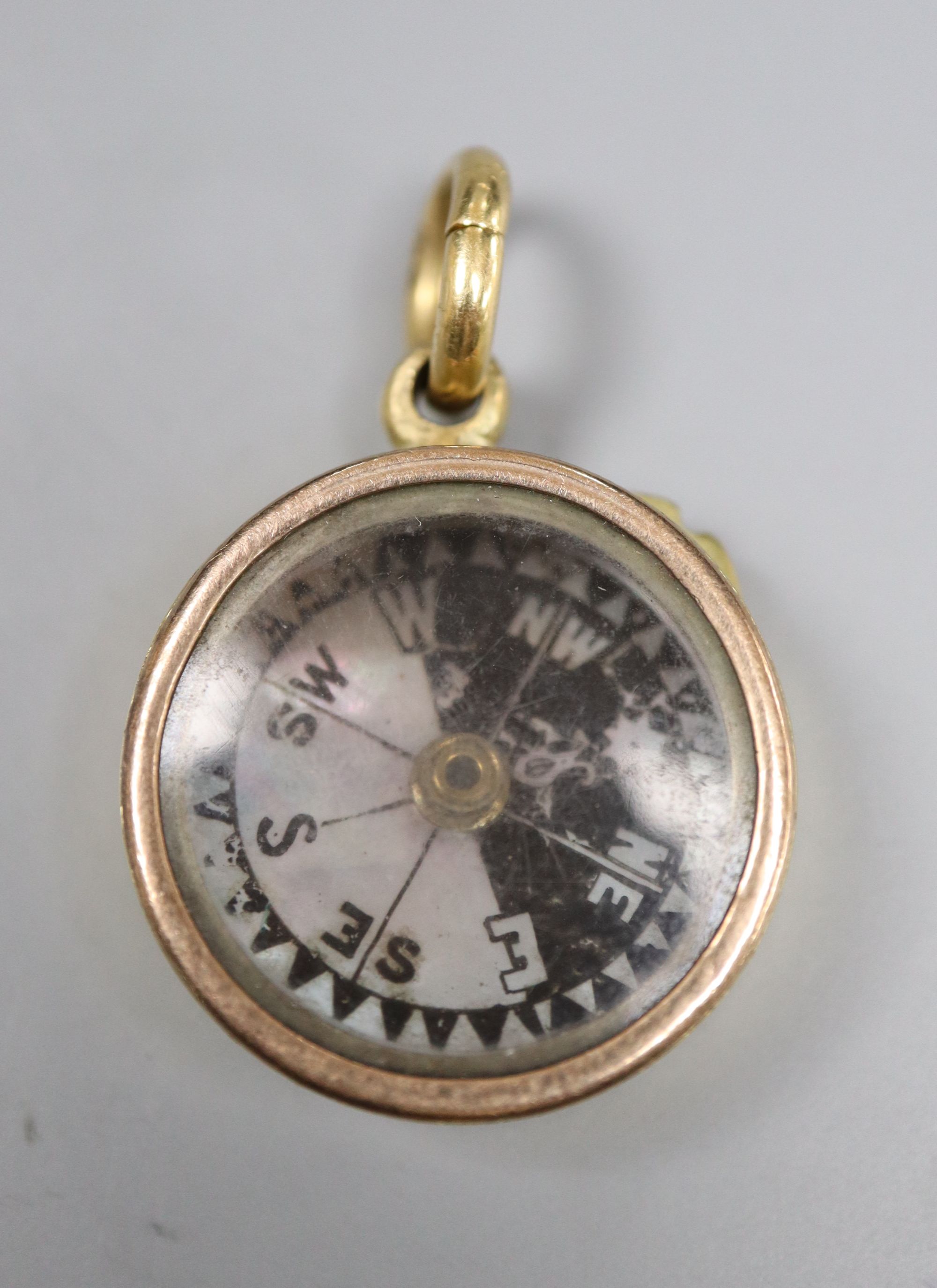 An 18ct cased pendant compass, with bale, 22mm, gross 14 grams.